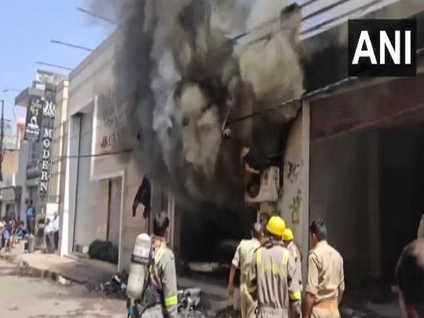 Fire tenders deployed at a showroom in Pilibhit’s Sarafa Market (Photo/ANI)