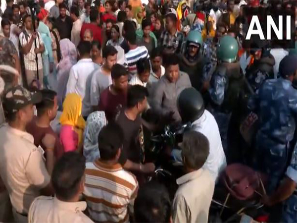 Locals in Seelampur block a road in the area on Friday (Photo/ANI)