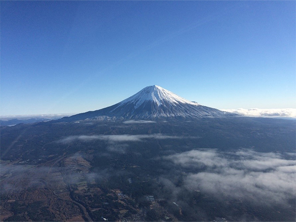 Mt. Fuji Japan snow-capped mountain above clouds.
