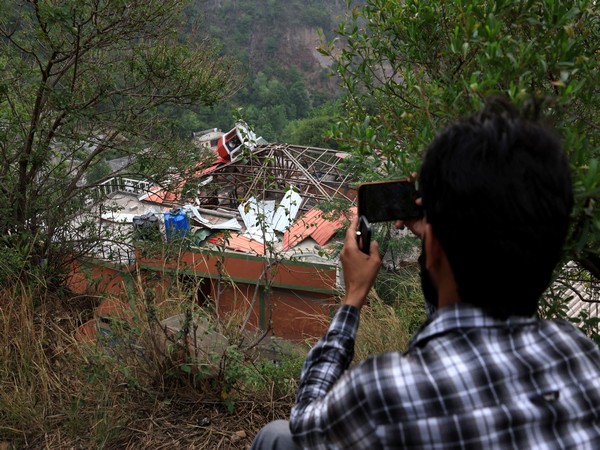 A media person films Bilal Mosque after it was hit by an Indian strike in Muzaffarabad, the capital of Pakistan-administered Kashmir (Image/ANI)