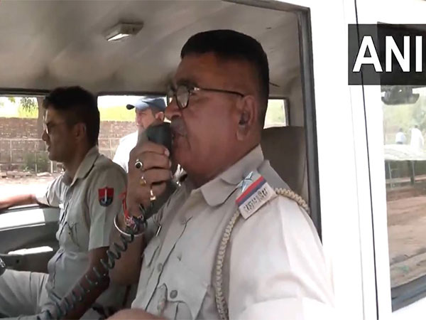 Police officials making announcements for people to stay indoors (Photo/ ANI) 
