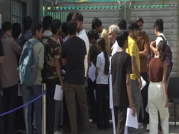 Students and Parents wait outside exam center (Photo/ANI)