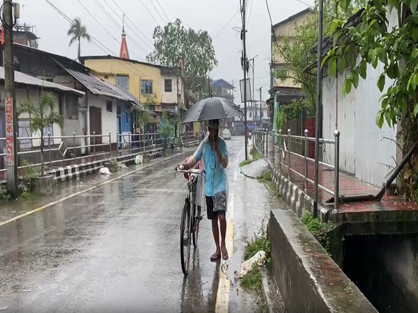 Local resident of Dibrugarh as the city recieve rain for third day (Photo/ANI) Local resident of Dibrugarh as the city recieve rain for third day (Photo/ANI)