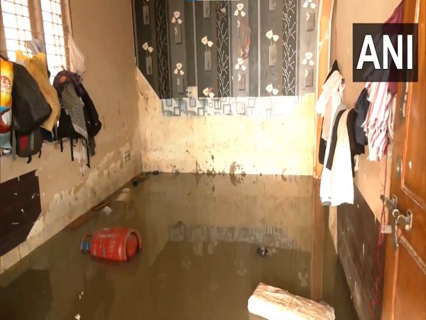 Heavy rainfall lashed several parts of Bengaluru, causing severe waterlogging and flooding in residential areas. (Photo/ANI)