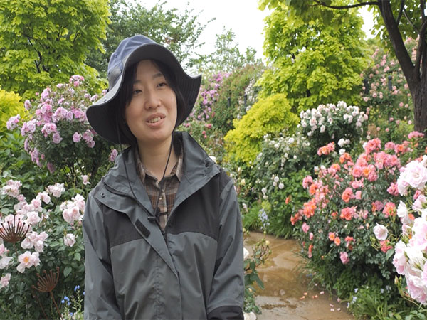 Mayu Kawasaki, gardener at Yokohama English Garden, stands among blooming roses. (Photo: ANI)