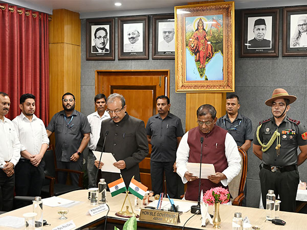 Assam Governor Lakshman Prasad Acharya administers oath to State Election Commissioner Ranjan Sharma. (Photo/ANI)