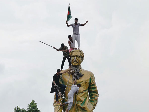 People climb the statue of Sheikh Mujibur Rahman at the Bijoy Sarani area, as they celebrate the resignation of the Prime Minister Sheikh Hasina in Dhaka (Image/Reuters)