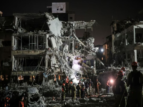 Rescue and security personnel work at an impact site following missile attack from Iran on Israel, in Ramat Gan (Image/Reuters)