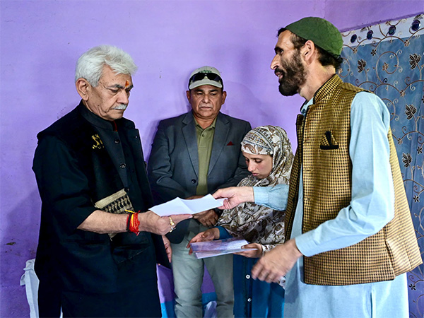 J&K LG Manoj Sinha hands job letter to his wife Gulnaz Akhter. (Photo/X/@OfficeOfLGJandK)