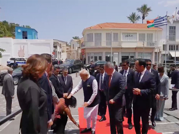 Cyprus council member Michaela Kythreoti Mhlapa touches PM Modi’s feet (Photo/ ANI)