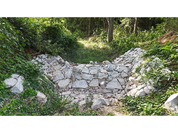 This boulder check dam increases soul moisture & minimizes erosion