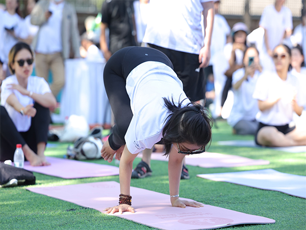 A woman performs yoga in Beijing (Image: X@EOIBeijing)