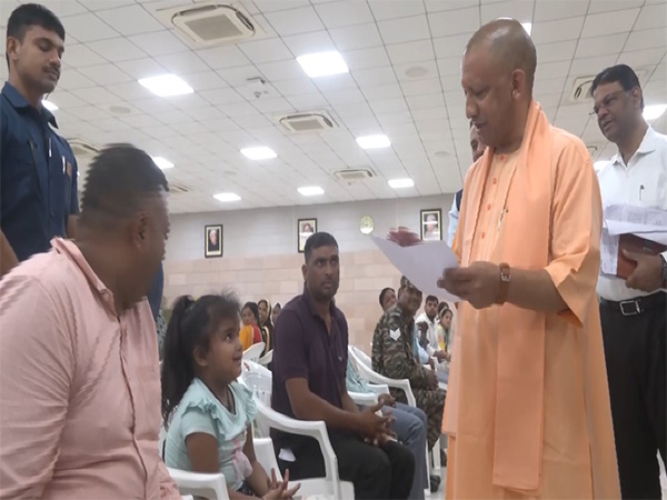 CM Yogi interacting with the girl at Janta Darshan (Photo/ANI)