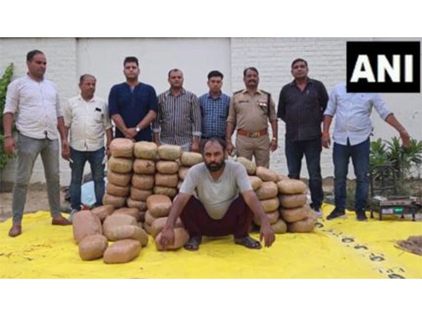 Police officials with seized ganja and arrested individual (Photo/ANI) 