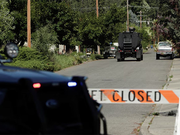 An armored police vehicle moves towards an area where multiple firefighters were attacked when responding to a fire in the Canfield Mountain area outside Coeur d’Alene, Idaho (Image/Reuters)