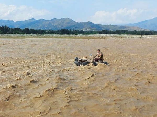 A rescue worker rows a raft while searching for survivors, after tourists, who were on a picnic, were swept away by overflowing floodwaters in the Swat River, in Swat Valley in Pakistan (Image/Reuters)