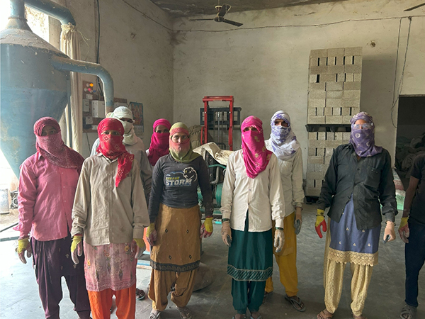A group photo of women farmers trained by Gohemp, turning agricultural residue into eco-friendly building bricks