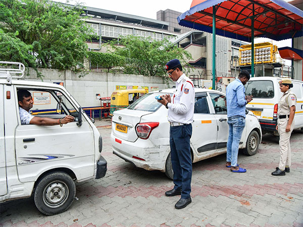 A Delhi traffic police official checks the validity of vehicle (Photo/ANI)