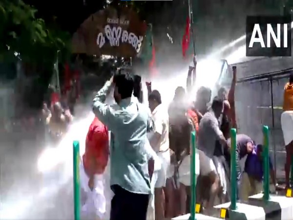 Police use water cannon to disperse the BJP workers taking out a protest march. (Photo/ANI)