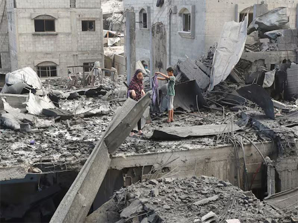 Palestinians inspect the site of Thursday's Israeli strike that damaged and destroyed residential buildings, at Shati (Beach) refugee camp, in Gaza City (Image/Reuters)