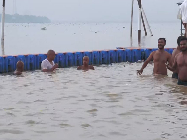 Devotees take holy dip on Devshayani Ekadashi. (Photo/ANI)