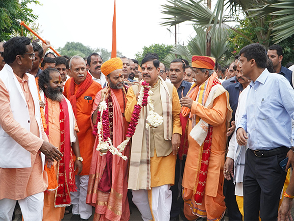 Madhya Pradesh CM Mohan Yadav holding Kanwar (Photo/DPR)