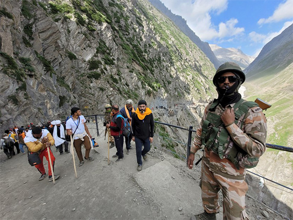 Security personnel stand guard as pilgrims arrive during Shri Amarnath Yatra (Filephoto/ANI)