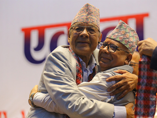 Chairman of CPN-Unified Socialist Madhav Kumar Nepal (Right) hugs chairman of CPN Unity National Campaign Bamdev Gautam (Left) following the announcement on 18 July (Photo/ANI)