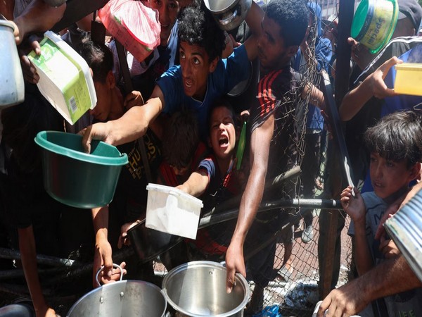 Starving Palestinians scramble for food aid in Nuseirat, central Gaza Strip, on July 20 (Source: Reuters)