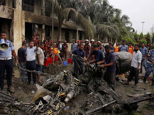 Firefighters work to remove the wreckage from a building, after an air force training aircraft crashed into Milestone College campus, in Dhaka (Image/ANI)