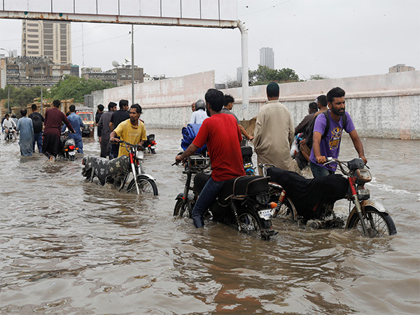 Commuters navigate waterlogged streets amid heavy monsoon rains in Pakistan (Photo/Reuters)