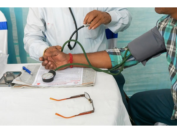A doctor checking the blood pressure of a patient