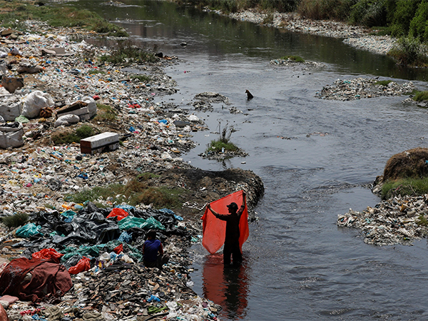A man washes plastic sheets for recycling in polluted waters on World Environment Day in Karachi (File Photo/Reuters) A man washes plastic sheets for recycling in polluted waters on World Environment Day in Karachi (File Photo/Reuters)