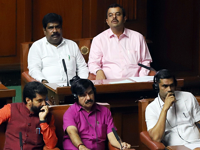 Independent MLA H Nagesh sitting with BJP MLAs during the trust vote. (Photo/ANI)