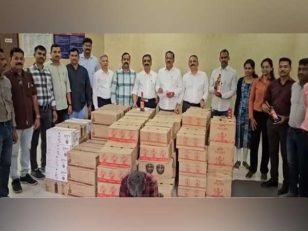 Maharashtra Excise Department officials with seized foreign liquor (Photo/ANI)