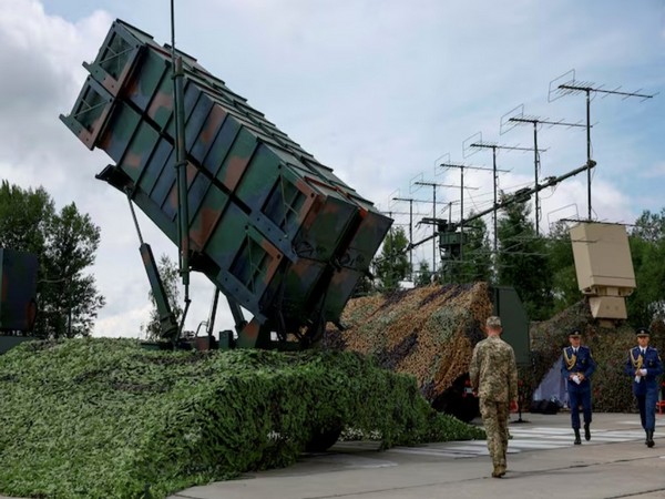 Ukrainian service members walk next to a launcher of a Patriot air defence system (Image/Reuters)