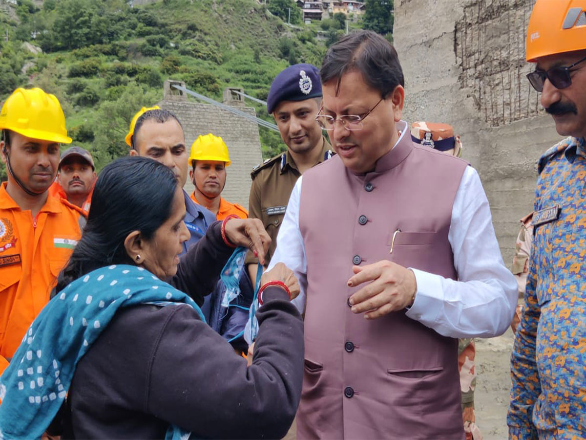 Gujarati tourist stuck in Uttarakhand due to floods ties rakhi to CM Dhami (Photo/X @pushkardhami) 