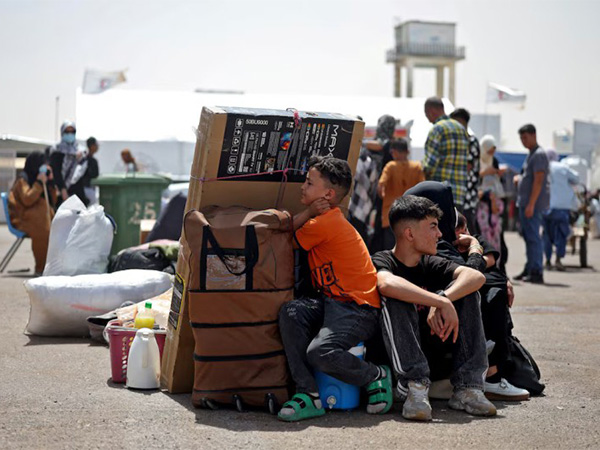 An Afghan family deported from Iran rests with their belongings at a camp for returning migrants near the Islam Qala border crossing in Herat province, Afghanistan (File Photo/Reuters)