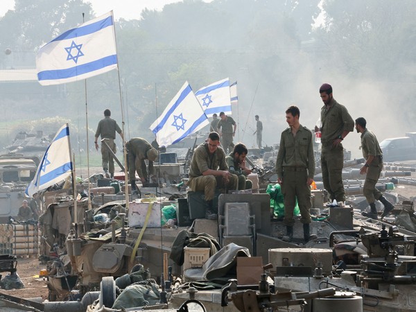 Israeli soldiers stand on tanks near the Israel-Gaza border in southern Israel amid the ongoing conflict with the Palestinian Islamist group Hamas (File Photo/Reuters)