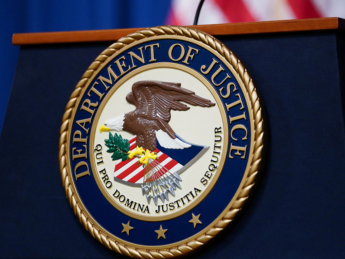 The seal of the U.S. Department of Justice is displayed on the podium in the Department’s headquarters briefing room ahead of a news conference with the Attorney General (File Photo/Reuters)