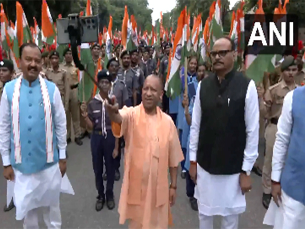 Uttar Pradesh Chief Minister Yogi Adityanath taking selfies with young people at tiranga rally (Photo/ANI)