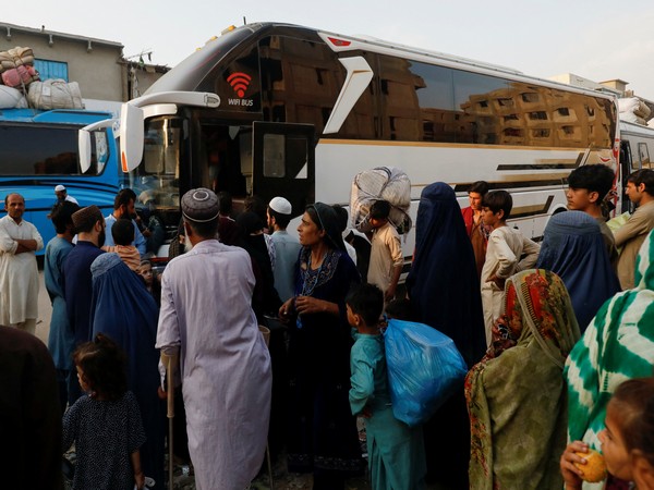 Afghan nationals gather near a bus as part of ongoing repatriation efforts amid a crackdown on undocumented residents in Pakistan (File Photo/Reuters)