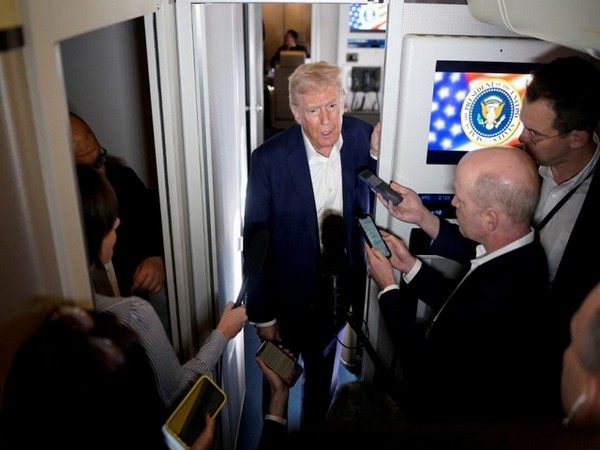 US President Donald Trump addresses the media aboard Air Force One (File Photo/Reuters)