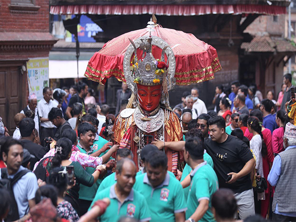 Devotees touch and offer alms to the giant Dipankar Buddha idol as it is paraded through the streets of Bhaktapur during the Panchadan festival (Photo/ANI)