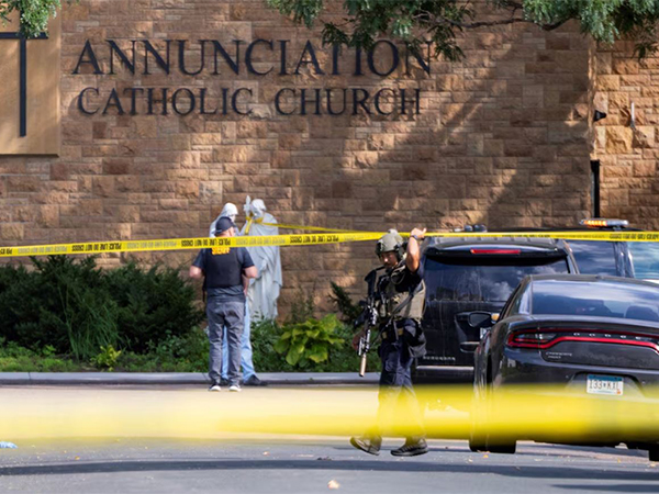 Law enforcement officers set up barriers after a shooting at Annunciation Church, which is also home to an elementary school, in Minneapolis, Minnesota (Image/Reuters)