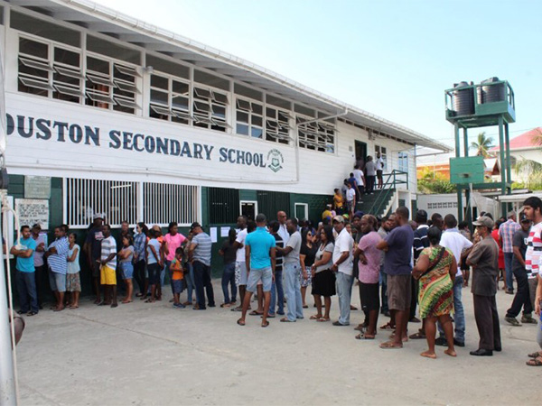 People line up to cast their votes in Guyana’s presidential elections in Georgetown (Photo/Reuters)
