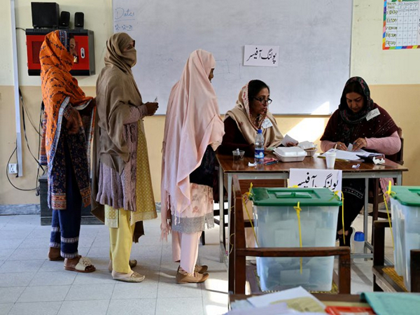 Election staff register voters at a polling station set up in a school during the general elections in Islamabad, Pakistan (Photo/Reuters)