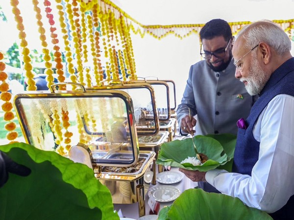 Guyana President Mohamed Irfaan Ali serves meal to PM Modi on a water lily leaf (File photo/ANI)