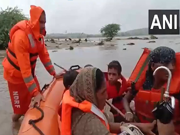 SDRF team rescues 9 people stranded in flooded Sabarmati River near Danta. (Photo/ANI)