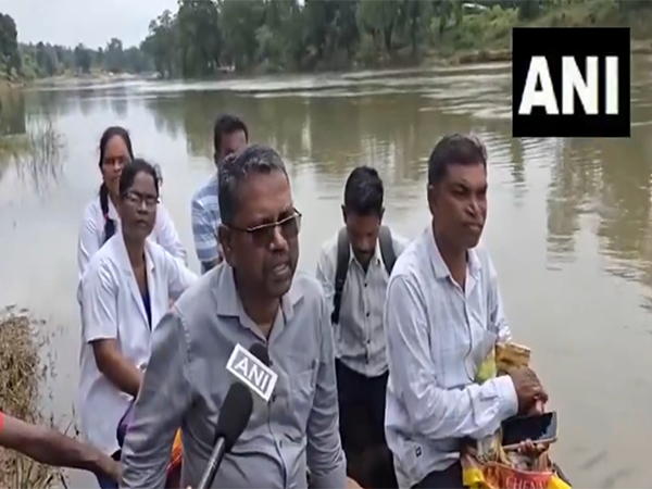 Bijapur CMHO Dr. BR Pujari and his team cross Chintavagu river by boat. (Photo @ANI_MP_CG_RJ)
